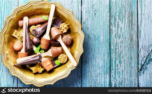 Chocolate delicious candy. Assortment of chocolate candies on stylish dish.Chocolate dessert.Chocolate sweets