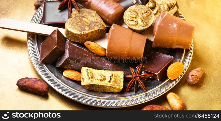 Chocolate delicious candy. Assortment of chocolate candies on stylish salver.Chocolate dessert.Chocolate sweets