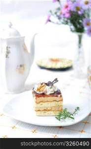 Chocolate dessert with tea, violet flowers and napkin