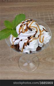 Chocolate dessert with whipped cream drizzled with topping