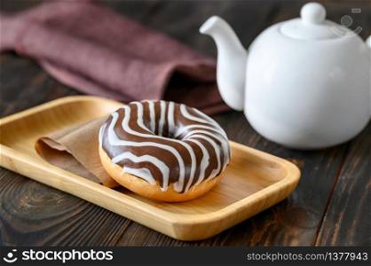 Chocolate donut on wooden plate
