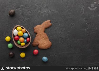 chocolate easter egg filled with colorful candy bunny shaped cookie