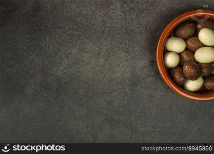 Chocolate easter eggs, candies on concrete background. Horizontal orientation, place for copyspace, flatlay, top view. Happy Easter concept dark design. Chocolate easter eggs, candies on concrete background. Horizontal orientation, place for copyspace, flatlay, top view. Happy Easter concept