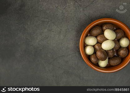 Chocolate easter eggs, candies on concrete background. Horizontal orientation, place for copyspace, flatlay, top view. Happy Easter concept dark design. Chocolate easter eggs, candies on concrete background. Horizontal orientation, place for copyspace, flatlay, top view. Happy Easter concept