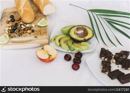 chocolate fruits dryfruits with bread white backdrop