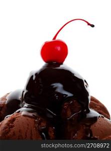 Chocolate ice cream covered with gooey chocolate syrup and topped with a yummy red cherry. Shot on white background.
