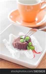 Chocolate lava cake with fork and coffee cup, stock photo