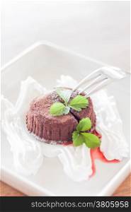 Chocolate lava with whipped cream and strawberry sauce, stock photo