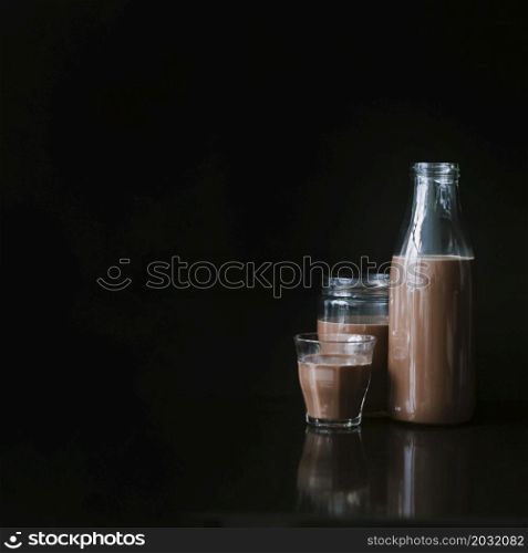 chocolate milk shake glass jar bottle black background