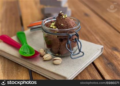 Chocolate mousse in a jar on a book