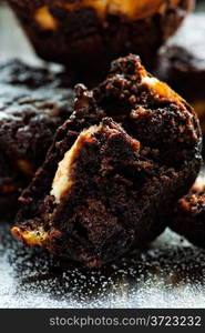 Chocolate muffin over dark background, closeup, selective focus