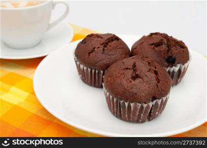 Chocolate Muffins and Coffee on Orange Tablecloth
