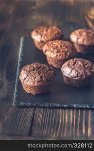 Chocolate muffins on the black stone board