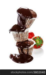 Chocolate muffins with chocolate sauce and berry over white