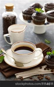 Chocolate muffins with fresh blueberry and cofee cup for breakfast