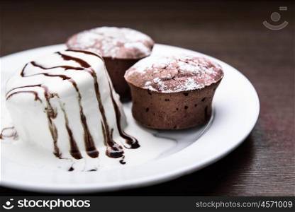 chocolate muffins with ice cream drizzled with chocolate topping