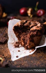 Chocolate muffins with nuts on dark background, selective focus