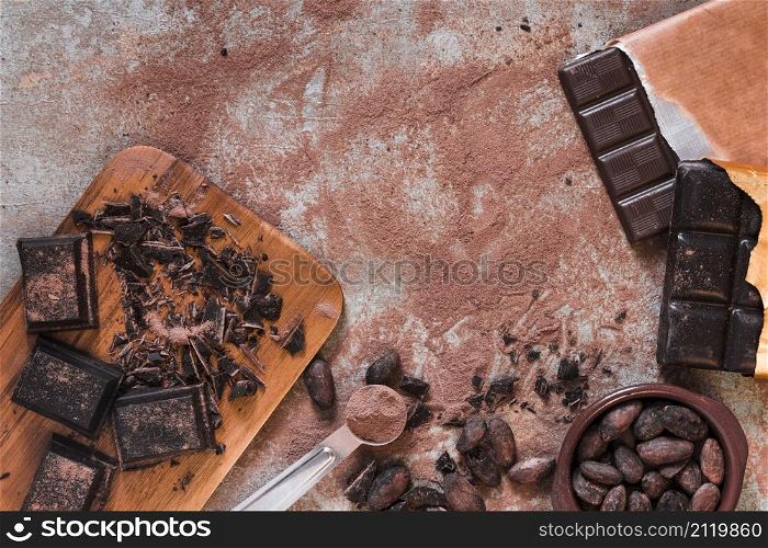 chocolate pieces bar cocoa powder beans bowls messy table