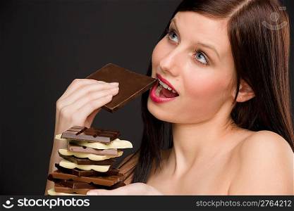 Chocolate - portrait of healthy woman enjoy sweets on black background