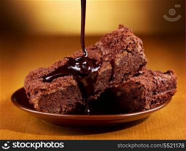 chocolate pouring over slices of chocolate cake