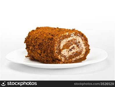 chocolate roll on white dish, grey background