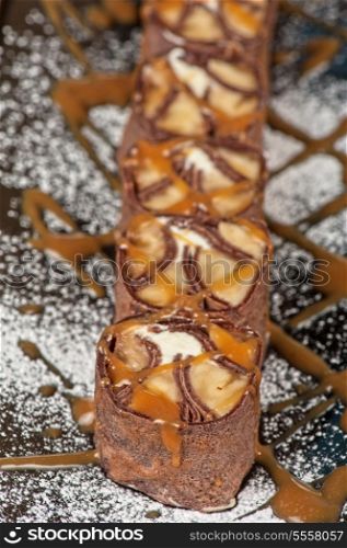 Chocolate roll with various caramel and cream