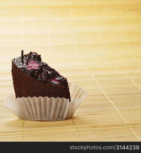 Chocolate sacher cake on bamboo table cloth