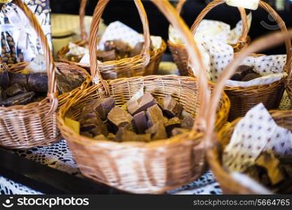 Chocolate shop. Pieces of natural product in baskets