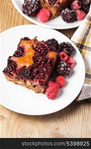 Chocolate sponge cake with blackberries and raspberries and walnuts