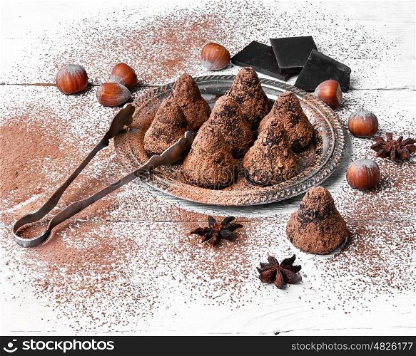 Chocolate truffles balls. Chocolate truffles candies with cocoa powder and nuts