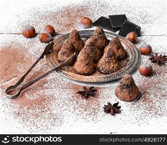 Chocolate truffles balls. Chocolate truffles candies with cocoa powder and nuts