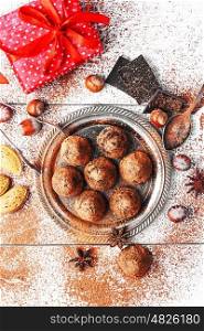 Chocolate truffles balls. Chocolate truffles with cocoa and nuts and red box with gift