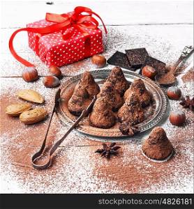 Chocolate truffles balls. Chocolate truffles with cocoa and nuts and red box with gift