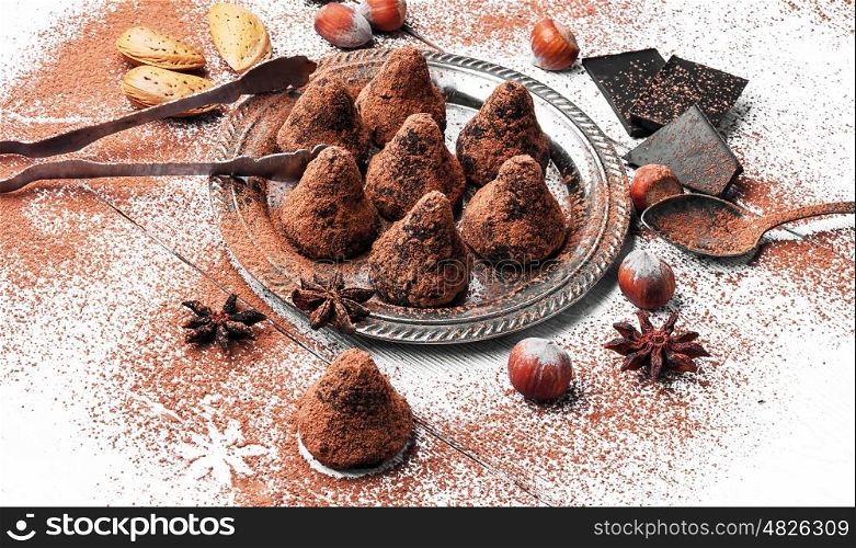 Chocolate truffles candies with cocoa powder and nuts. Chocolate truffles balls