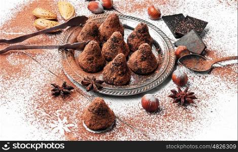 Chocolate truffles candies with cocoa powder and nuts. Chocolate truffles balls