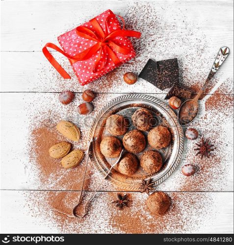 Chocolate truffles candy. Chocolate truffles with cocoa and nuts and red box with gift