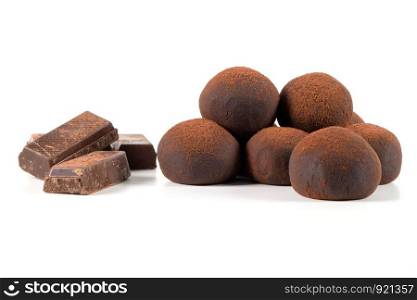Chocolate truffles with chocolate parts isolated on white background.