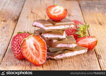 chocolate with strawberry cream on wooden background&#xA;