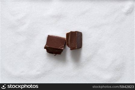 Chocolate with sugar as a background. Chocolate with sugar as a background.