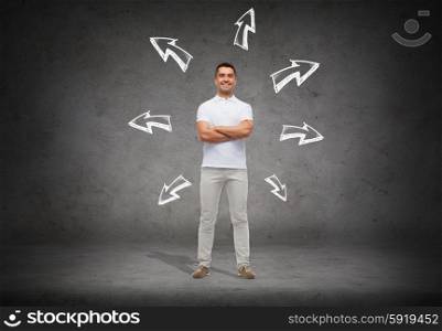 choice, direction, possibilities and people concept - smiling man in white t-shirt with crossed arms over arrow doodles and concrete background