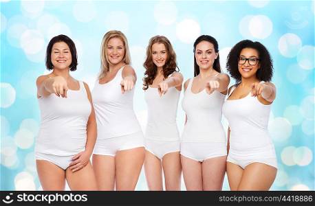 choice, friendship, beauty, body positive and people concept - group of happy different women in white underwear pointing finger on you over blue holidays lights background