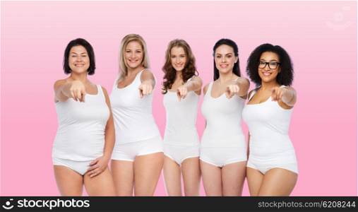 choice, friendship, beauty, body positive and people concept - group of happy different women in white underwear pointing finger on you over pink background