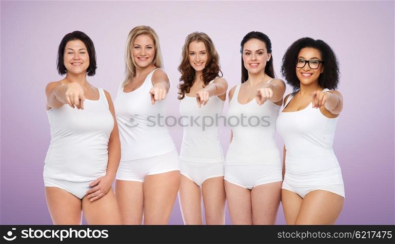choice, friendship, beauty, body positive and people concept - group of happy different women in white underwear pointing finger on you over violet background