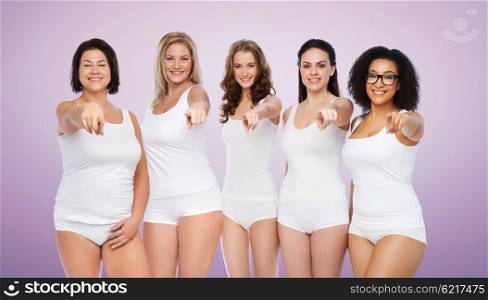 choice, friendship, beauty, body positive and people concept - group of happy different women in white underwear pointing finger on you over violet background