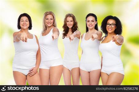 choice, friendship, beauty, body positive and people concept - group of happy different women in white underwear pointing finger on you over green natural background