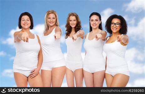 choice, friendship, beauty, body positive and people concept - group of happy different women in white underwear pointing finger on you over blue sky and clouds background