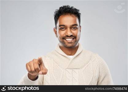 choice, gesture and people concept - smiling indian man pointing finger to camera over grey background. smiling indian man pointing finger to camera