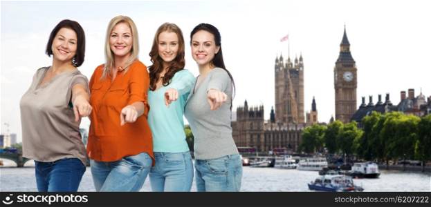 choice, travel, tourism, diverse and people concept - group of happy plus size women in casual clothes pointing finger on you over london city and big ben tower background