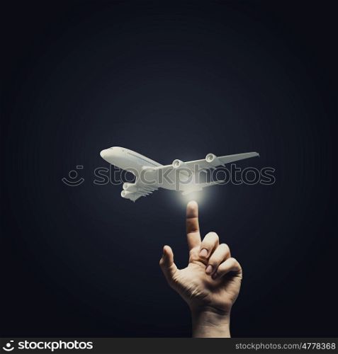 Choice your flight. Human hand pressing with finger touch screen airplane button