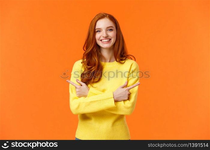 Choices, shopping, winter holidays concept. Cute smiling redhead girl with curly red hair, yellow sweater, pointing sideways, cross hands over chest showing left and right product, event promo.. Choices, shopping, winter holidays concept. Cute smiling redhead girl with curly red hair, yellow sweater, pointing sideways, cross hands over chest showing left and right product, event promo